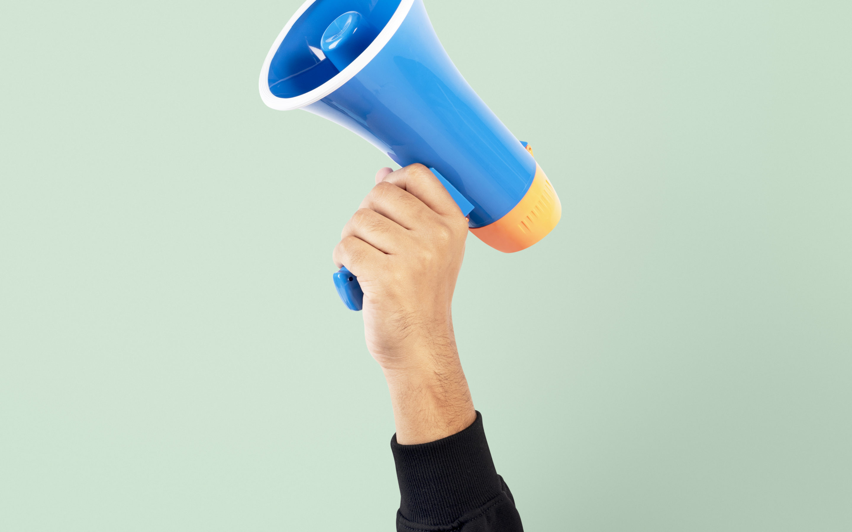 Hand holding megaphone marketing announcement campaign